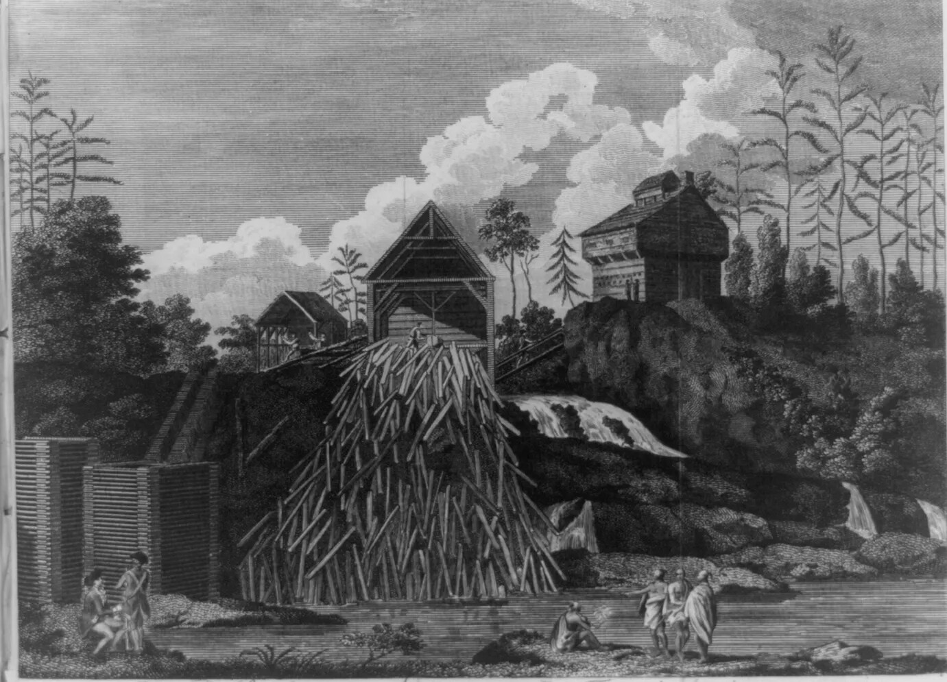 A black and white drawing of a pile of logs falling off the side of a cliff. At the top of the cliff are three multi-storied houses, which sit next to a waterfall. At the base of the cliff are several people standing and sitting along the shore of a small body of water.