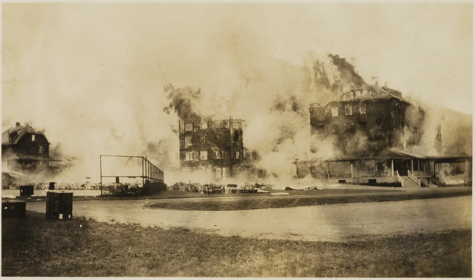 A black and white photograph of a multi-storied building on fire.
