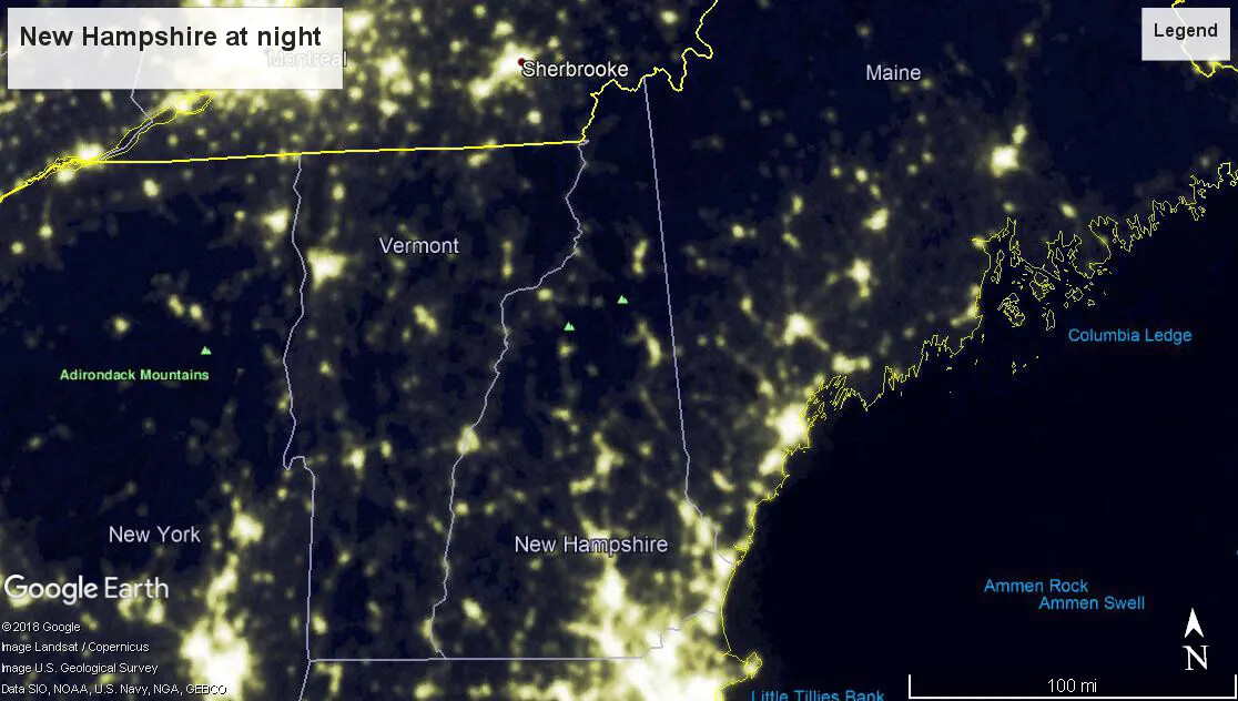 A colored close-up screenshot of Maine, New Hampshire, Vermont, and New York at night from Google Earth. The states are outlined in white. The Canadian border and the coast of Maine on the Atlantic Ocean are outlined in yellow. Groupings of the color yellow are scattered around each state, while the rest of the land mass in each state is black and gray.