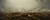 A large, rectangle, color painting of a battle has many details. The sky covers the top half of the painting, and has bright and dark grey parts, but generally is distinguished by the many columns of smoke rising from the battle. The battle covers a large, wide open landscape and the viewer can see far into the distance where the battle ranges. Various details visible include riderless horses, men dead on the ground, Civil War cannons being fired, groups of infantry soldiers fighting at close quarters, men on horseback charging, and battered flags flying. 