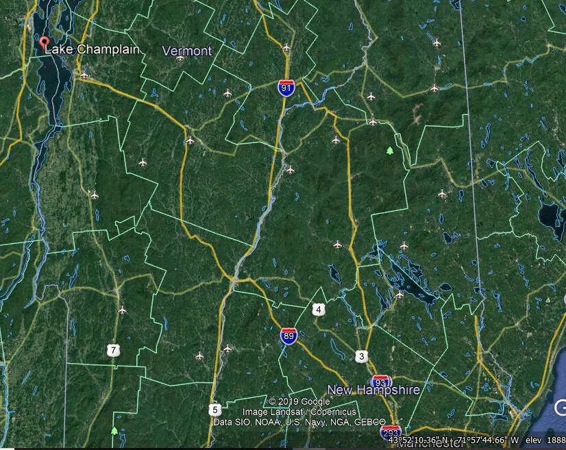 A colored screenshot from GoogleEarth of Vermont and New Hampshire. The majority of the map is dark green, with county and state borders visible in different colored lines. Several highways and routes are also marked on the map.
