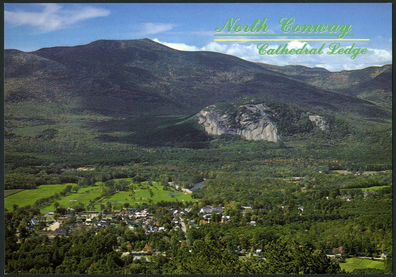 A colored horizontal postcard of a large green mountain in the background and a valley of flat green land scattered with trees. The title of the postcard, placed in the upper right-hand corner, reads "North Conway/Cathedral Ledge."