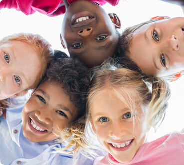 Kids in a circle looking down